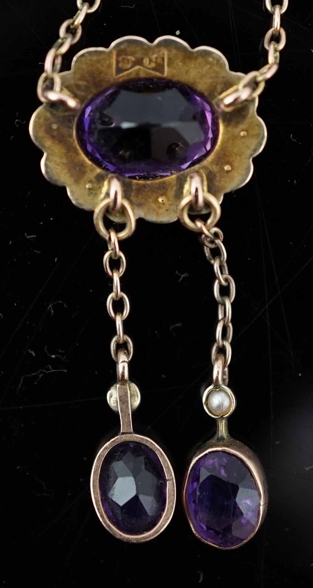 A cased Edwardian 9ct gold, amethyst and seed pearl cluster set double drop pendant necklace
